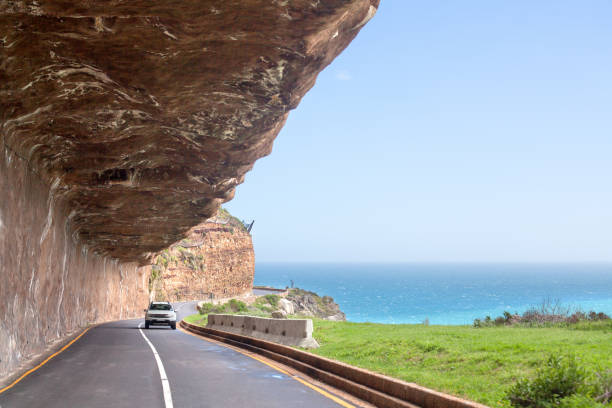 Mountain road along the sea coast, turquoise ocean water seascape, blue sky, azure sea panorama, summer vacation concept, beautiful mountain view landscape, Cape Town, South Africa coast travel Cape Town, South Africa - September 16, 2017: Mountain road along the sea coast, turquoise ocean water seascape, blue sky, azure sea panorama, summer vacation concept, beautiful mountain view landscape, Cape Town, South Africa coast travel chapmans peak drive stock pictures, royalty-free photos & images