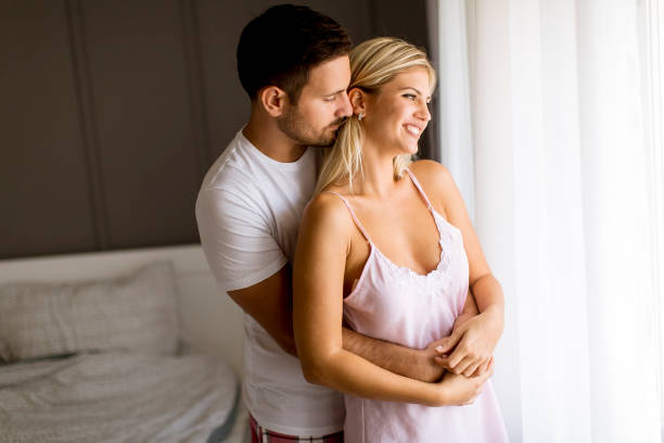 istock Lovely young couple standing by the window 1131140340