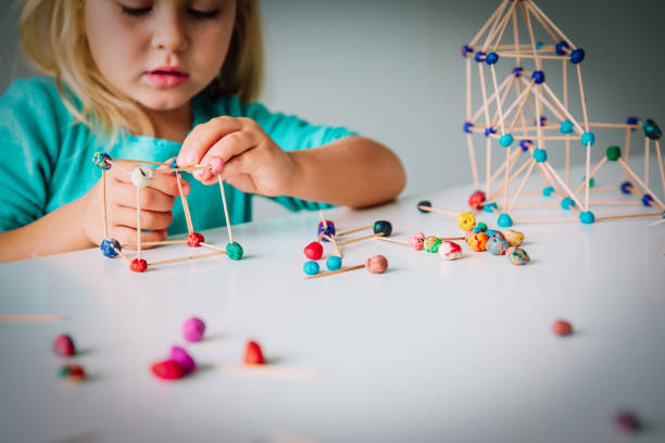 istock little girl making geometric shapes, engineering and STEM 1131140575