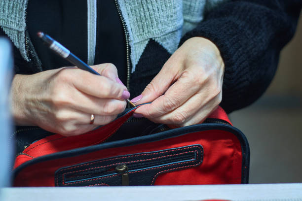 istock Close-up woman's hands working with a leather bag. 1131140718