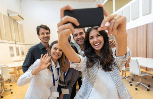 istock Happy group of business people taking a selfie at a creative office 1131140729