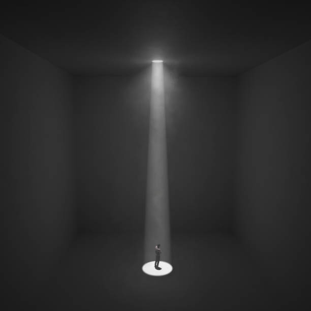istock man stands under the ray of light in a dark room, 1131140895