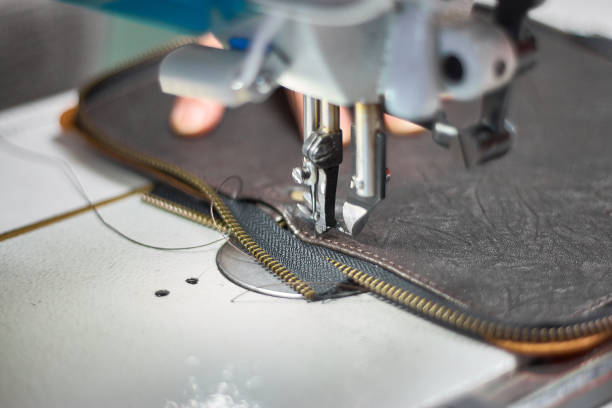 istock Designer stitching a fragment of a leather bag on the sewing machine 1131141005