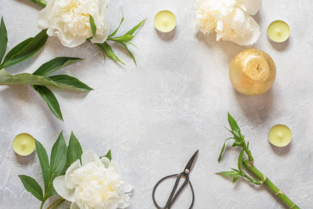 istock Creative spring flat lay. White peony flowers,candels, leaves, on light vintage table. Copy space. 1131142139