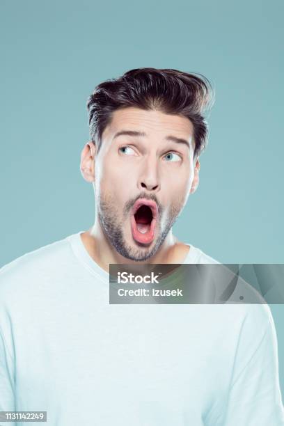 Surprised Young Man Looking Away Stock Photo - Download Image Now - 25-29 Years, Adult, Adults Only