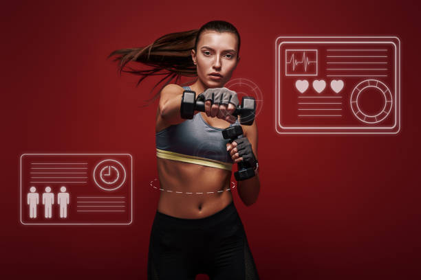 istock Never stop Sportswoman is exercising with dumbbells standing over red background. Game concept. 1131144636