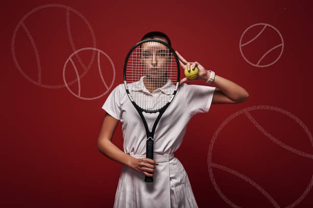 istock Refuse to Lose Young tennis player standing over red background with a racket and a ball. Graphic drawing. 1131145209