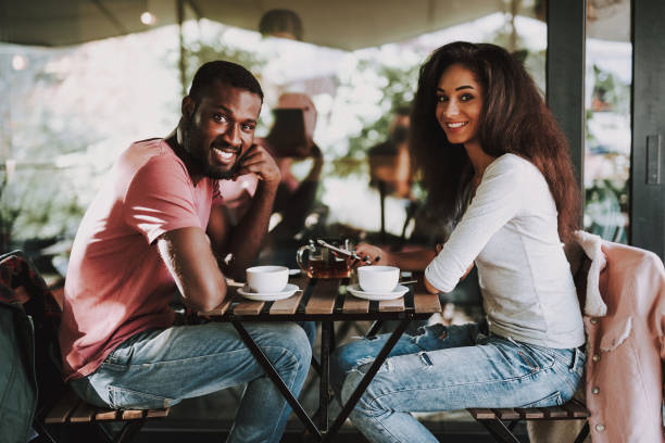 istock Cheerful female and male drinking tea in cafe 1131147231