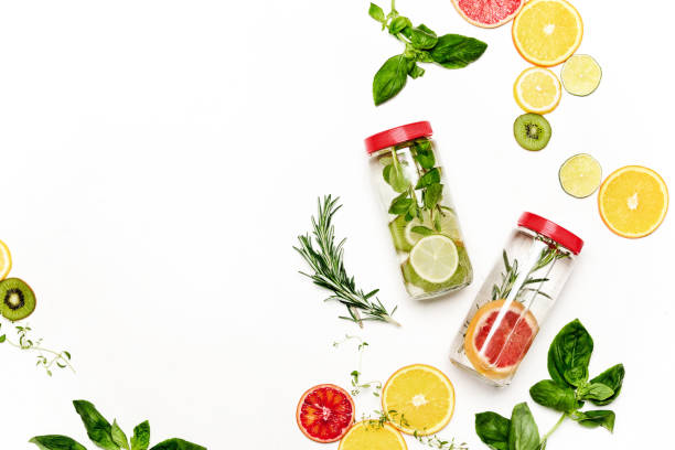 Infused waters with various ingredients background Infused water in bottles with various ingredients such as culinary aromatic herbs and fruits, healthy lifestyle concept, overhead view, blank space for a text infused water stock pictures, royalty-free photos & images