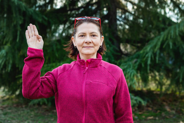 istock Woman using American sign language - hand gesture hello 1131148341