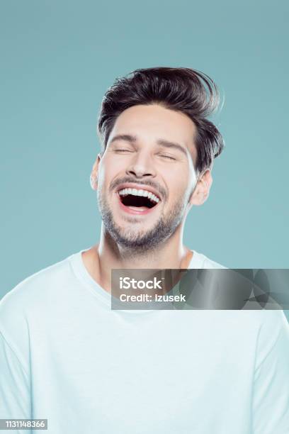 Close Up Of A Laughing Young Man Stock Photo - Download Image Now - Men, Human Face, Laughing