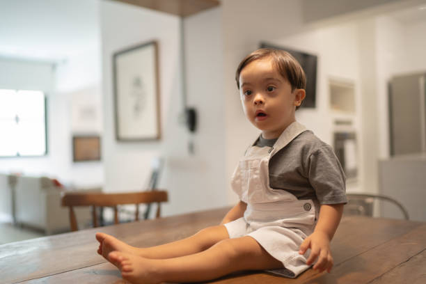 istock Down Syndrome Little Boy Sitting on Dinning Table 1131149040