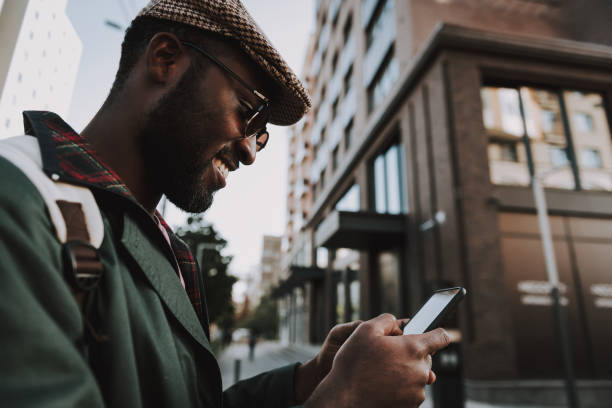istock Portrait of cheerful male type message on mobile 1131150175
