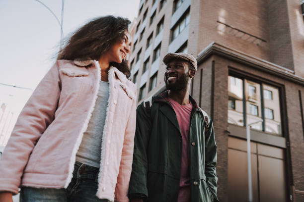 istock Smiling beloved couple walking on city background 1131150177