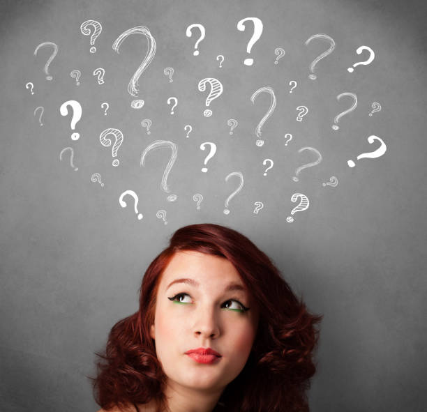 istock Young woman with question marks above her head 1131151075