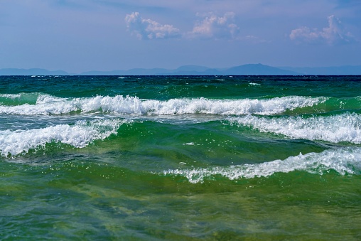sea and coastal landscape of a surf with a white foam wave