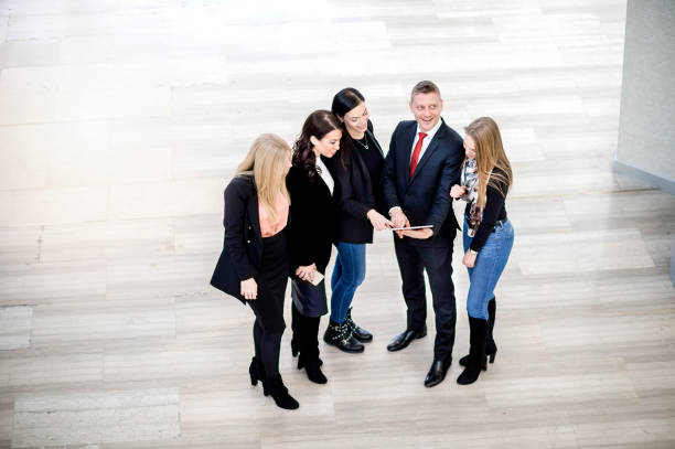 istock Business colleagues discussing in office building lobby 1131151551