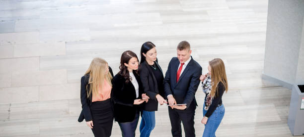 istock Business colleagues discussing in office building lobby 1131151894