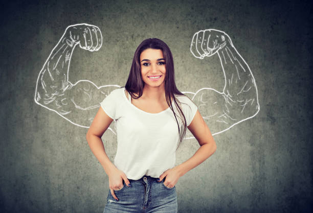 istock Strong happy young woman flexing her muscles 1131152898