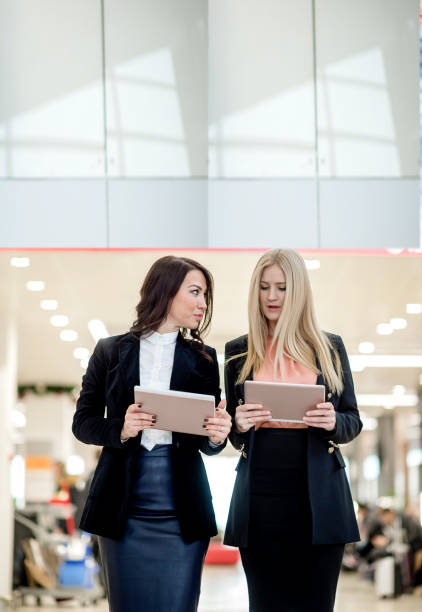 istock Female business passengers using digital tablet at airport 1131153146
