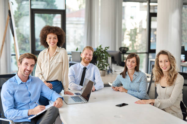 istock Small group of business people posing in office. 1131153981