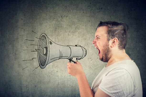 istock man screaming in loudspeaker making an announcement 1131154227