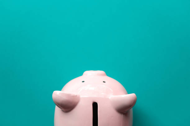 istock Piggy bank on blue background saving concept. 1131154422