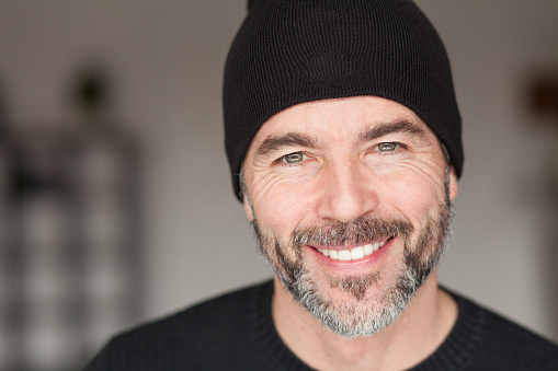 Senior man with a toque smiling at the camera