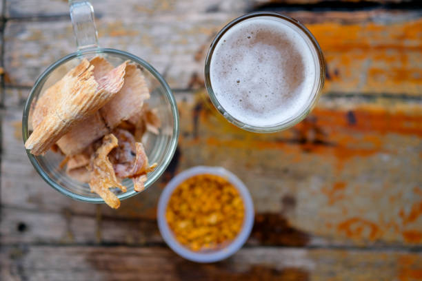 Thai food dried squid grilled grinding served with spicy sauce sprinkled with peanuts. Eating appetizer with beer. Thai style