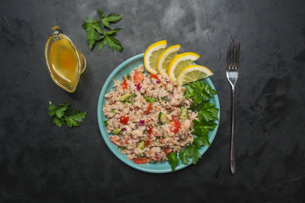istock Tuna Rice Salad in a plate on black table. 1131156925