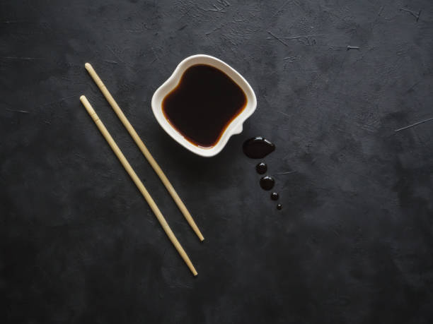 istock Chopsticks and soy sauce on black background. 1131156938