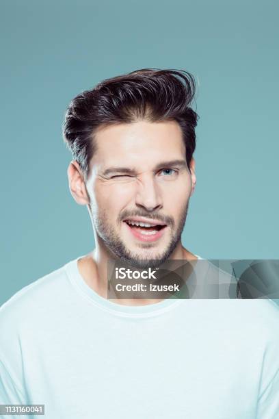 Handsome Young Man Winking Stock Photo - Download Image Now - Winking, Men, Males