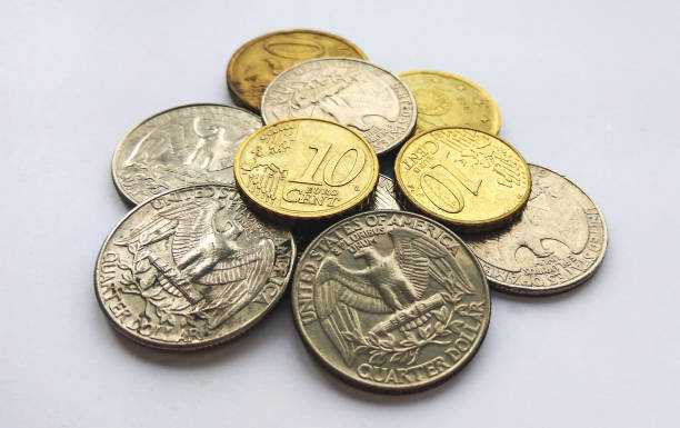 istock Euro and dollar cents on white background 1131160381