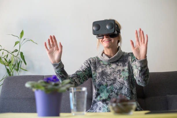 istock woman at home enjoying virtual reality goggles on sofa 1131160631