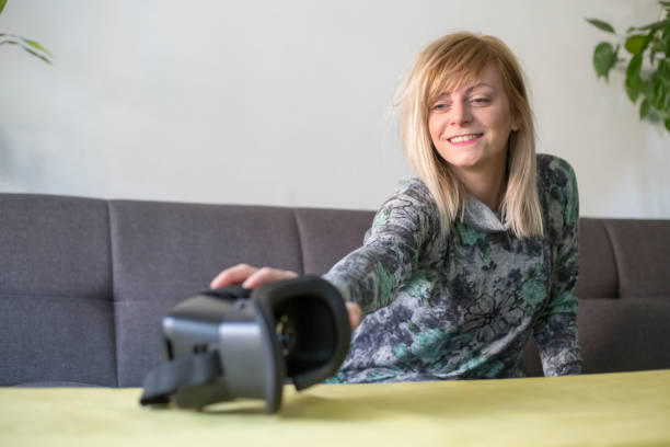 istock woman at home enjoying virtual reality goggles on sofa 1131160793