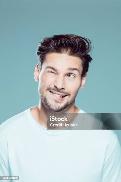 Close Up Of Naughty Young Man Stock Photo - Download Image Now - Men, Biting Lip, Studio Shot
