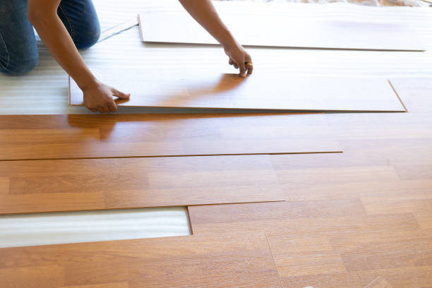 istock Man installing new laminated wooden floor 1131164304