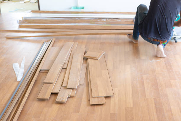 istock Man installing new laminated wooden floor 1131164392