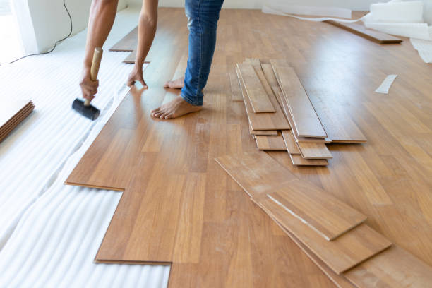 istock Man installing new laminated wooden floor 1131164922