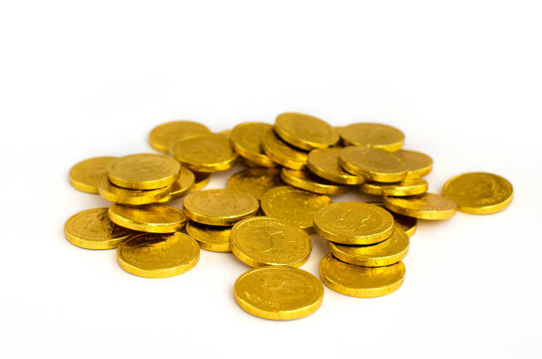 istock Bunch of chocolate gold coins on white background 1131167574