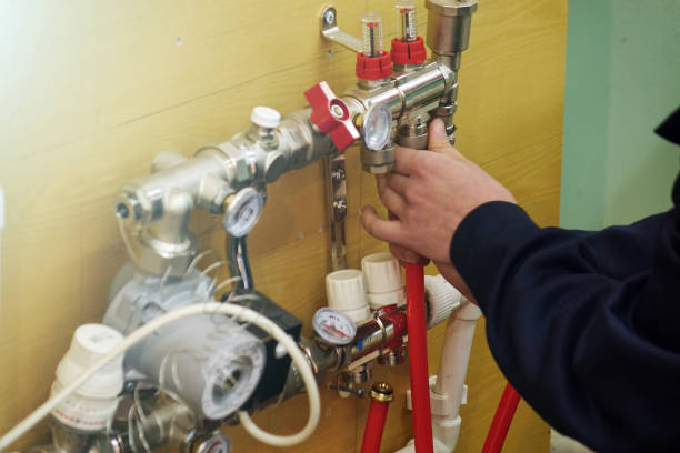 istock Radiant Floor Heating Installation Heating System. Man install underfloor water heating floor construction. 1131170519