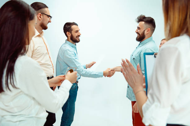 istock Boss approving and congratulating young successful employee 1131170541