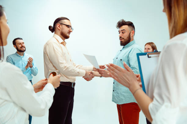 istock Boss approving and congratulating young successful employee 1131170553
