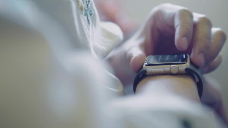 Woman using his smartwatch. She is checking emails, messages or using mobile applications.