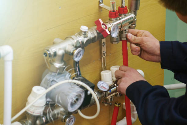 istock Radiant Floor Heating Installation Heating System. Man install underfloor water heating floor construction. 1131170656