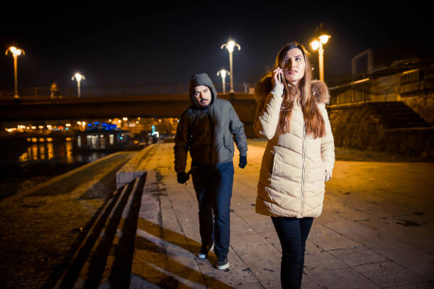 istock Man following woman at night 1131171299