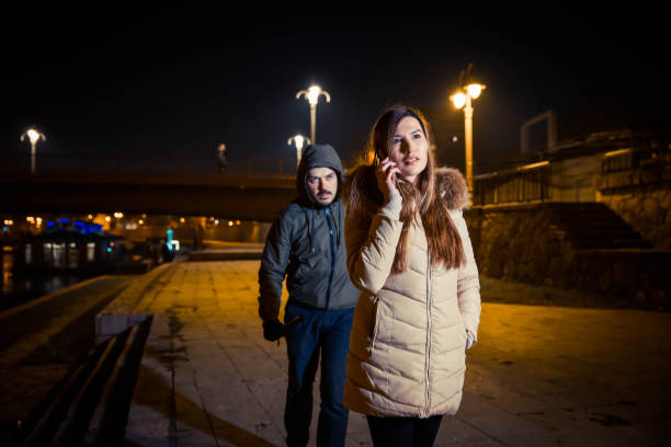 istock Man following woman at night 1131171350