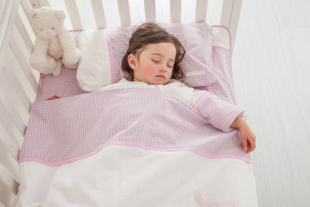 istock Little cute girl sleeping in bed 1131171540
