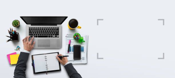 Office workplace with laptop, notebook, hand, office supplies, on white background. Solution, business planning, financial analysis, accounting, start up or working flat lay top view concept. stock photo