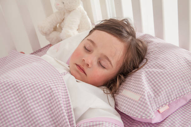 istock Little cute girl sleeping in bed 1131171649